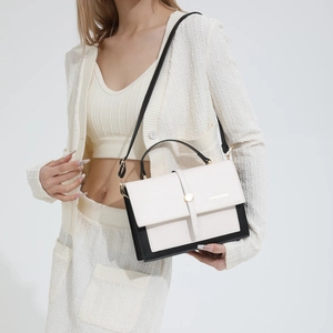 Modern color-block crossbody bag in cream and black with adjustable shoulder strap