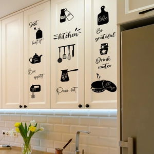 Detail of black silhouette kitchen decals and artistic typography on white cabinets