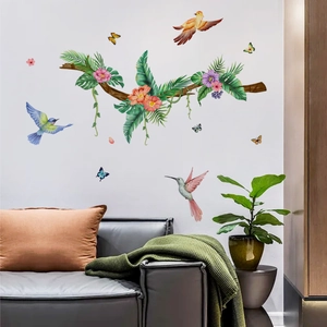 Detail of watercolor tropical birds and green vine wall stickers in a modern living room