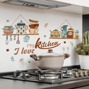 Detail of kitchen wall decal featuring vintage teapots and bowls with Kitchen text