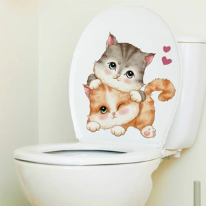 Detail of cute watercolor cat stickers with pink hearts on a white ceramic toilet lid