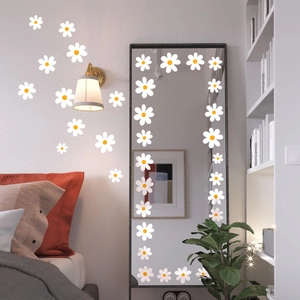 White daisy wall stickers in various sizes decorating a modern bedroom wall and mirror