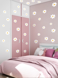 Close-up of small white daisy wall stickers applied on pink bedroom furniture and walls