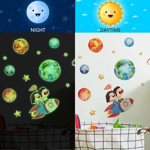Glow-in-the-dark space wall decals showing day and night comparison for kids rooms
