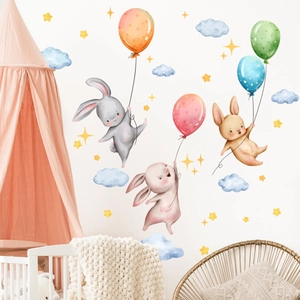 Watercolor cartoon rabbit and balloon wall stickers shown in a cozy baby nursery setting
