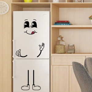 Funny cartoon face wall stickers on a white refrigerator in a cozy home setting