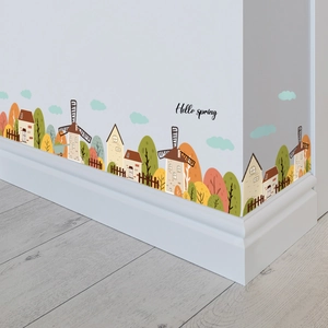 Détail de stickers muraux château et moulin sur des plinthes de chambre d'enfant