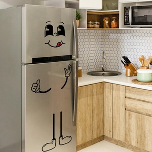Detail of funny cartoon facial expressions and gestures on a modern grey refrigerator
