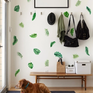 Macro detail of tropical monstera leaf wall stickers in a natural home entryway setting