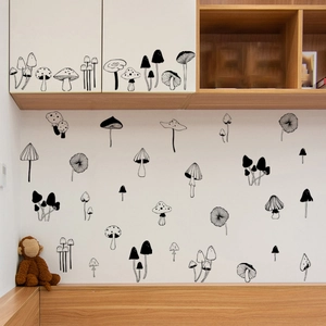Detail view of monochrome mushroom wall stickers in a cozy minimalist bedroom setting
