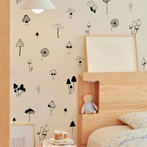 Minimalist black hand-drawn mushroom wall stickers in a cozy Nordic bedroom setting