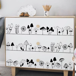 Minimalist black and white mushroom wall stickers on a modern white chest of drawers