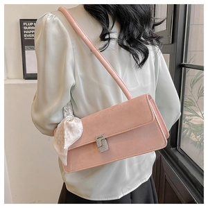 Detailed view of pink shoulder bag with letter G crystal buckle and printed silk scarf