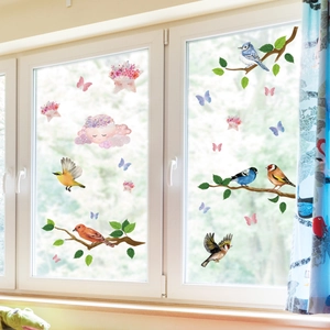 Detailed view of colorful bird and floral static window stickers on glass surface