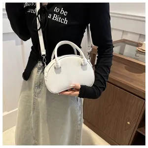 Minimalist white semi-circle handbag with top handles and a long detachable shoulder strap