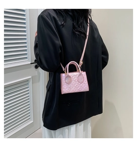 Elegant laser pink quilted crossbody bag styled with a minimalist outfit and gold hardware