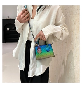 Detail of gradient quilted mini square bag with metallic finish and top handles