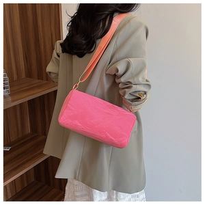 Pink pleated crossbody bag featuring a contrast coral orange wide shoulder strap detail