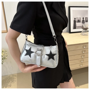 Silver shoulder bag with black star patches and metal star buckle detail for fashion