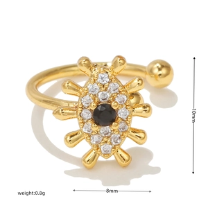 Macro shot showing dimensions and weight of a gold beetle ear clip with zircon stones