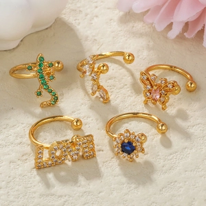 Detail of five-piece gold-plated jewelry set with butterfly and zircon lizard accents