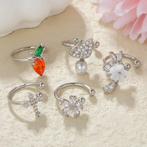 Detail of 5-piece silver ear cuff set with swan, flower, and zircon stone accents