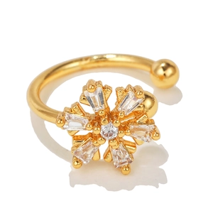 Close-up of a sparkling flower ear cuff with gold finish and inlaid zircon crystals