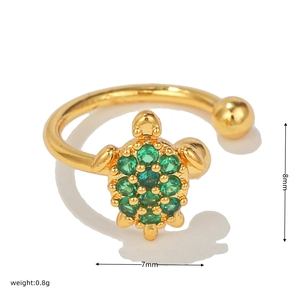 Detailed close-up of golden turtle ring with green zircons showing dimensions and weight