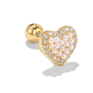 Close-up of golden heart earring with white pearls, zircons and screw back detail