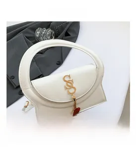 Detail of white PU leather bag featuring gold SS metal hardware and tassel decoration