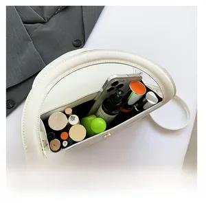 Top view of the white half-moon crossbody bag interior showing spacious daily storage