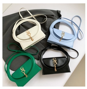 Detail view of four colorful crossbody bags with gold SS buckle and fringe charms