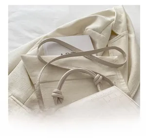 Detail showing creamy white crocodile texture surface and adjustable buckle strap