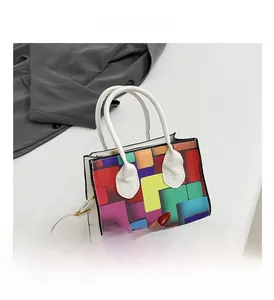 Detail of colorful geometric tote bag with white handles and detachable shoulder strap