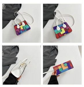 Detail view of colorful geometric square handbag with white handles and gold hardware