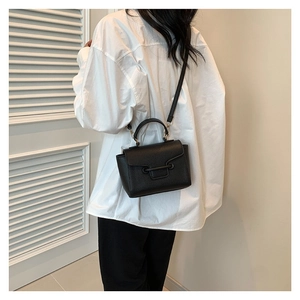 Chic black lychee texture crossbody bag with top handle for women in minimalist style