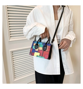 Detailed view of a small colorful geometric crossbody bag worn by a model