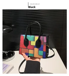Detail of colorful geometric block pattern on a black stylish small square handbag