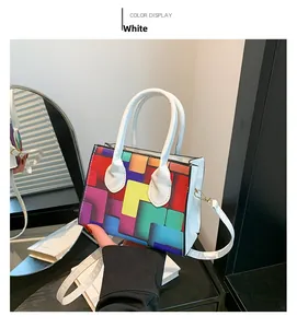 Detail view of colorful geometric pixel pattern on a mini square bag with white handle