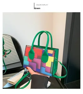 Detail of multi-color geometric patterned handbag with bright green handle and gold hooks