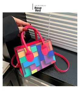 Detail view of the rose red cylindrical handle and colorful mosaic square pattern handbag