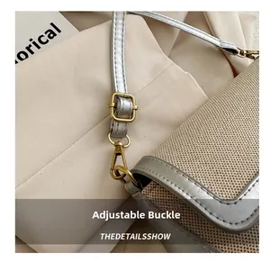 Detail of silver faux leather strap with vintage metal buckle on a woven crossbody bag