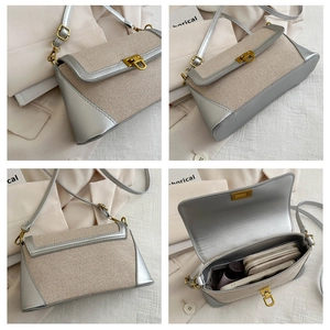 Detail view of stylish crossbody bag showing silver leather patchwork and metal buckle