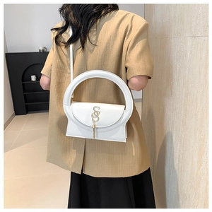 White trapezoid crossbody bag with large circular handle and gold SS metal charm clasp
