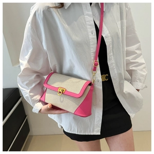 Fashionable woven crossbody bag with rose pink leather trim and gold twist lock clasp