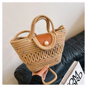 French woven straw handbag with colorful dots, leather flap, and pearl buckle detail