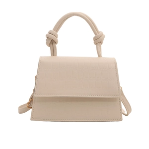 Beige faux crocodile leather handbag with elegant knot handle and crossbody strap
