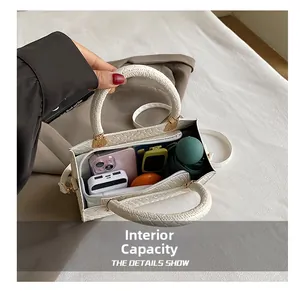 Detailed interior of a white woven texture handbag showing large storage capacity