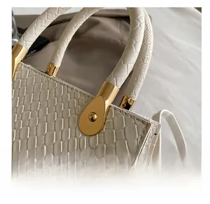 Macro shot of white crocodile texture leather and luxury golden metal hardware
