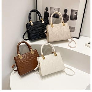Elegant woven leather handbags in black, beige, brown, and white with gold hardware